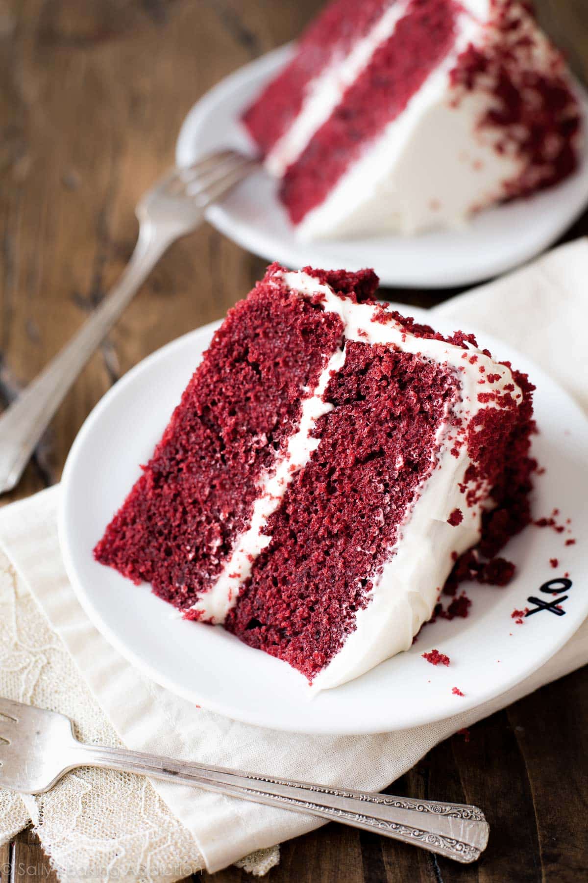 Slices of red velvet cake on white plates