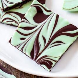 pieces of mint chocolate swirled bark on a white serving tray