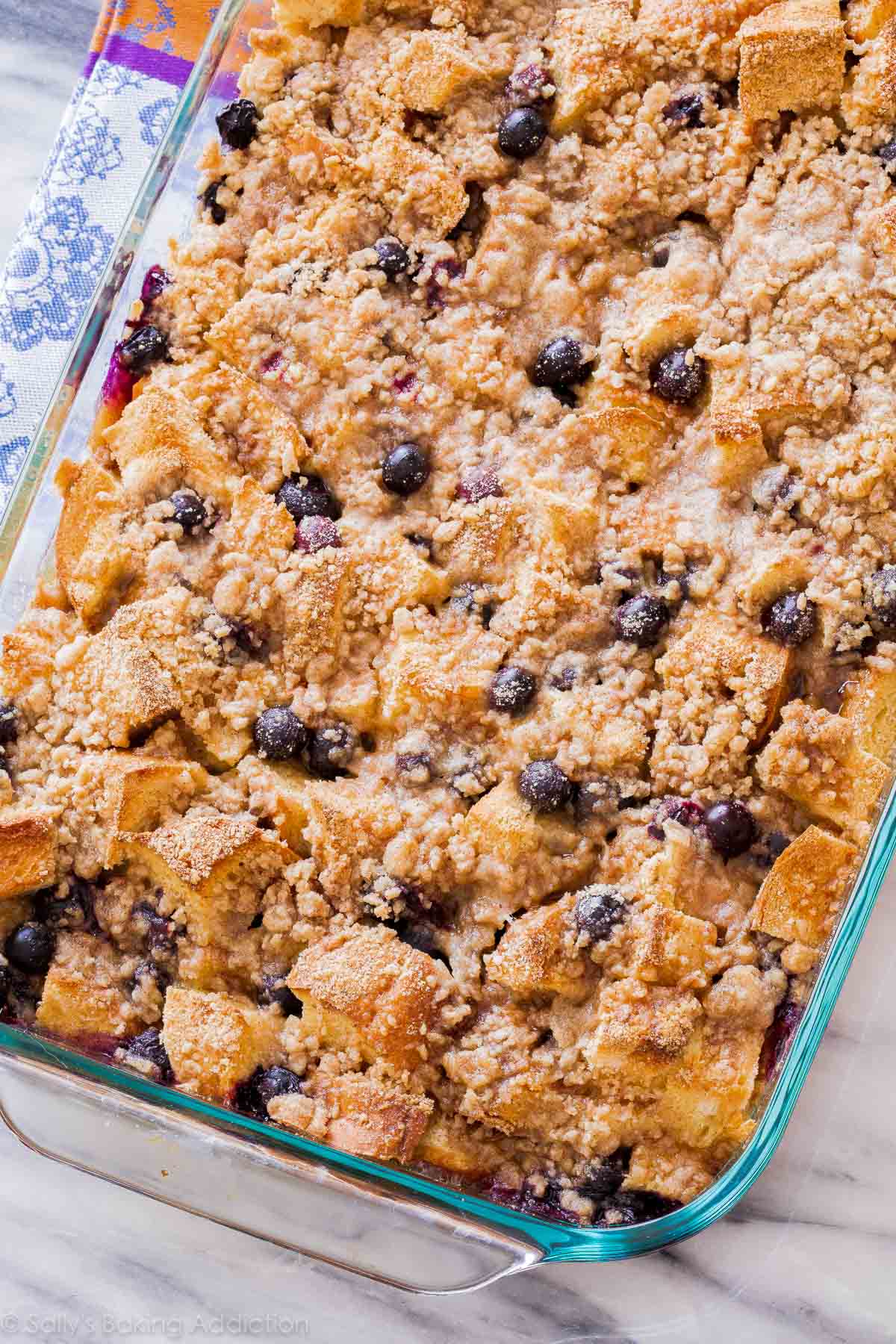 overhead image of blueberry french toast casserole in glass baking dish after baking