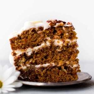 slice of carrot cake with cream cheese frosting on a plate