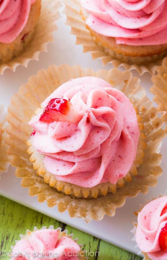 strawberry cupcakes topped with strawberry frosting