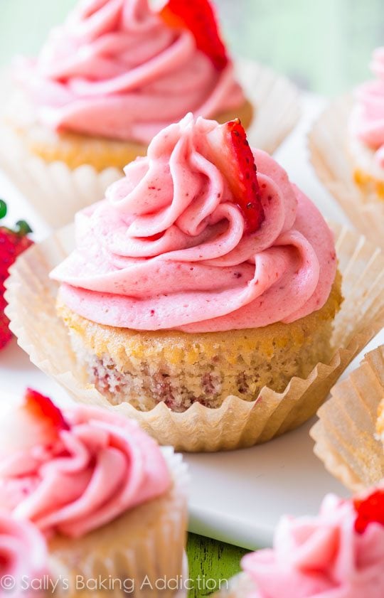 strawberry cupcakes topped with strawberry frosting