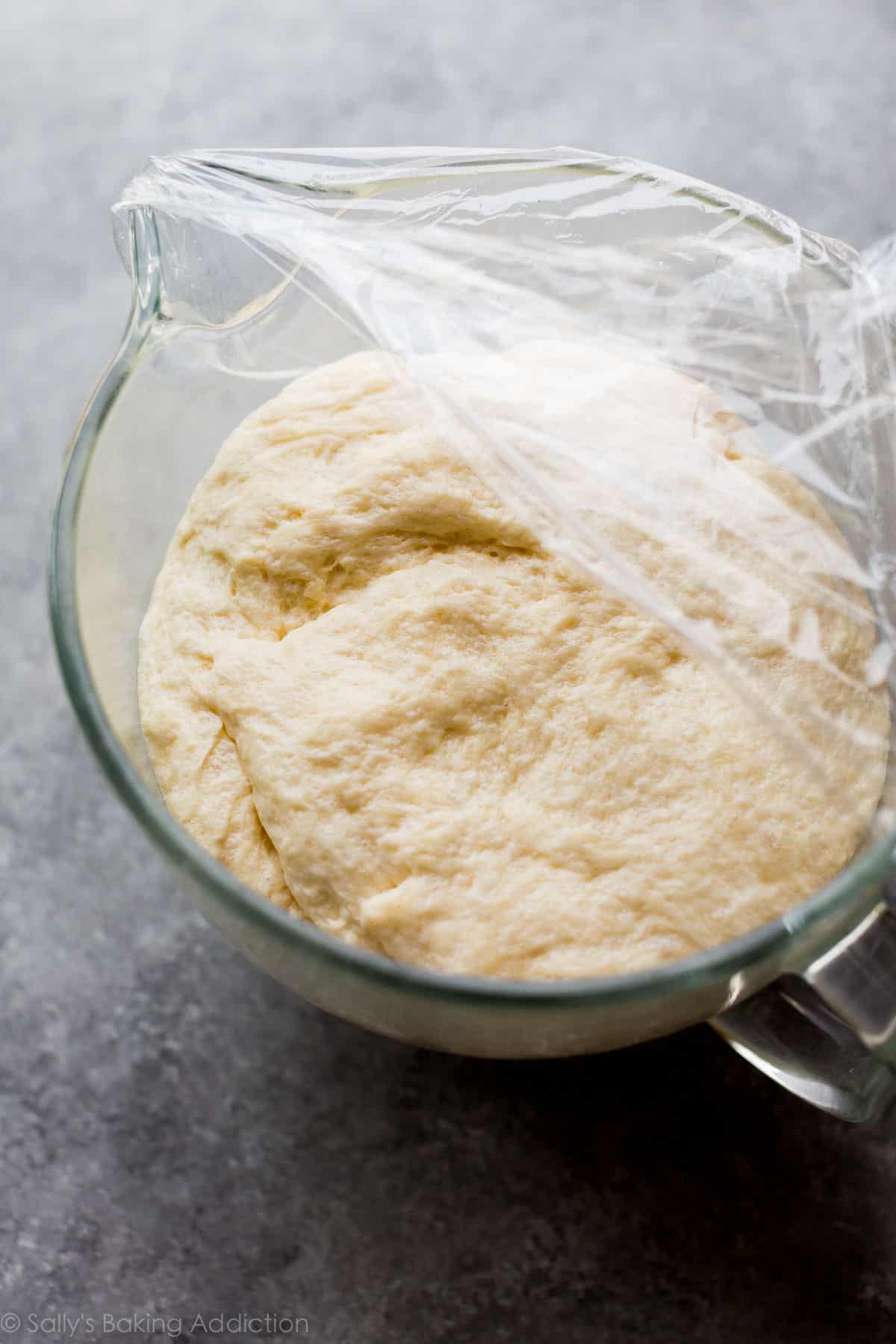 cinnamon swirl bread dough in a glass bowl