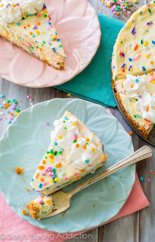 overhead image of slices of funfetti cheesecake on plates with forks