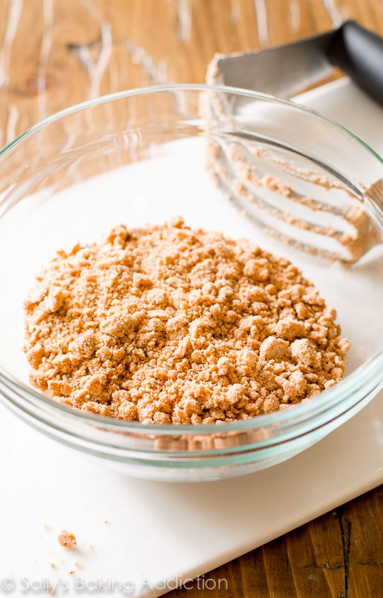crumb topping in a glass bowl with a pastry cutter