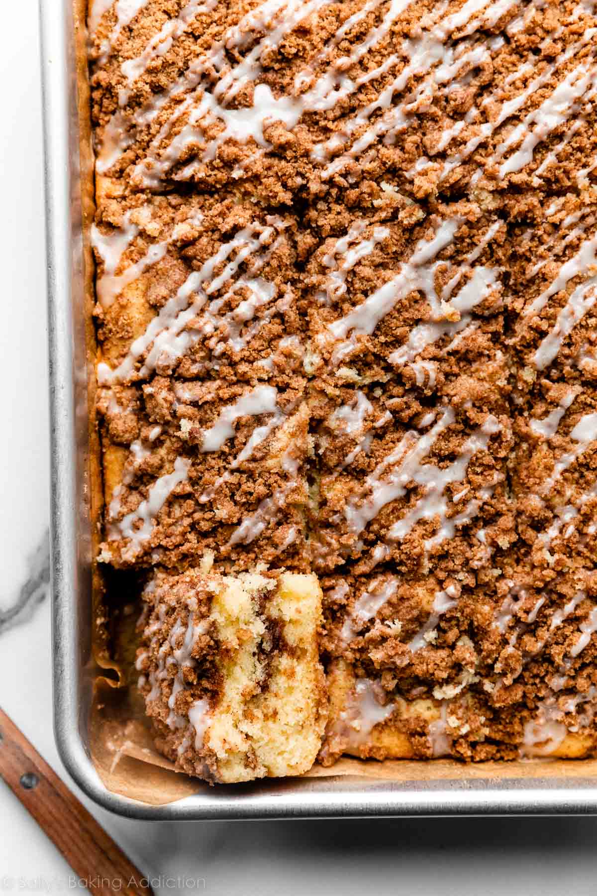 overhead photo of cinnamon crumb coffee cake cut into squares in pan.