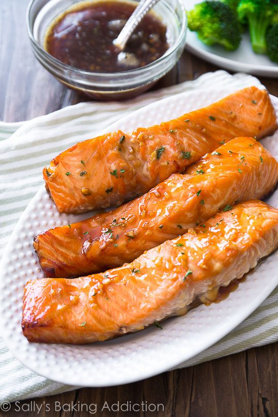 garlic honey ginger glazed salmon filets on a white serving plate