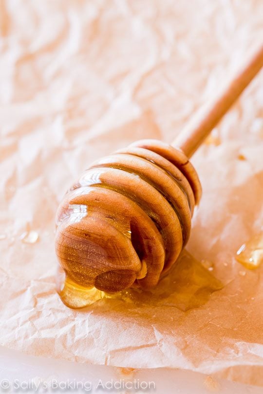 wood honey dipper with honey on it