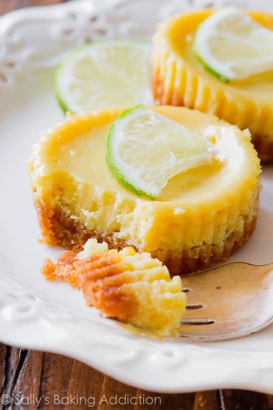 mini key lime pies on a white plate with a fork