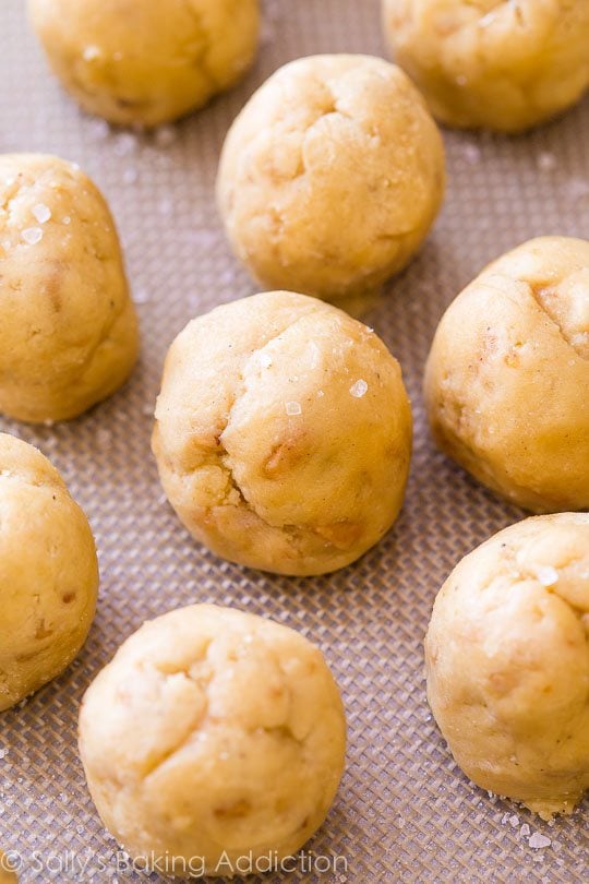 salted vanilla toffee cookie dough balls on a silpat baking mat
