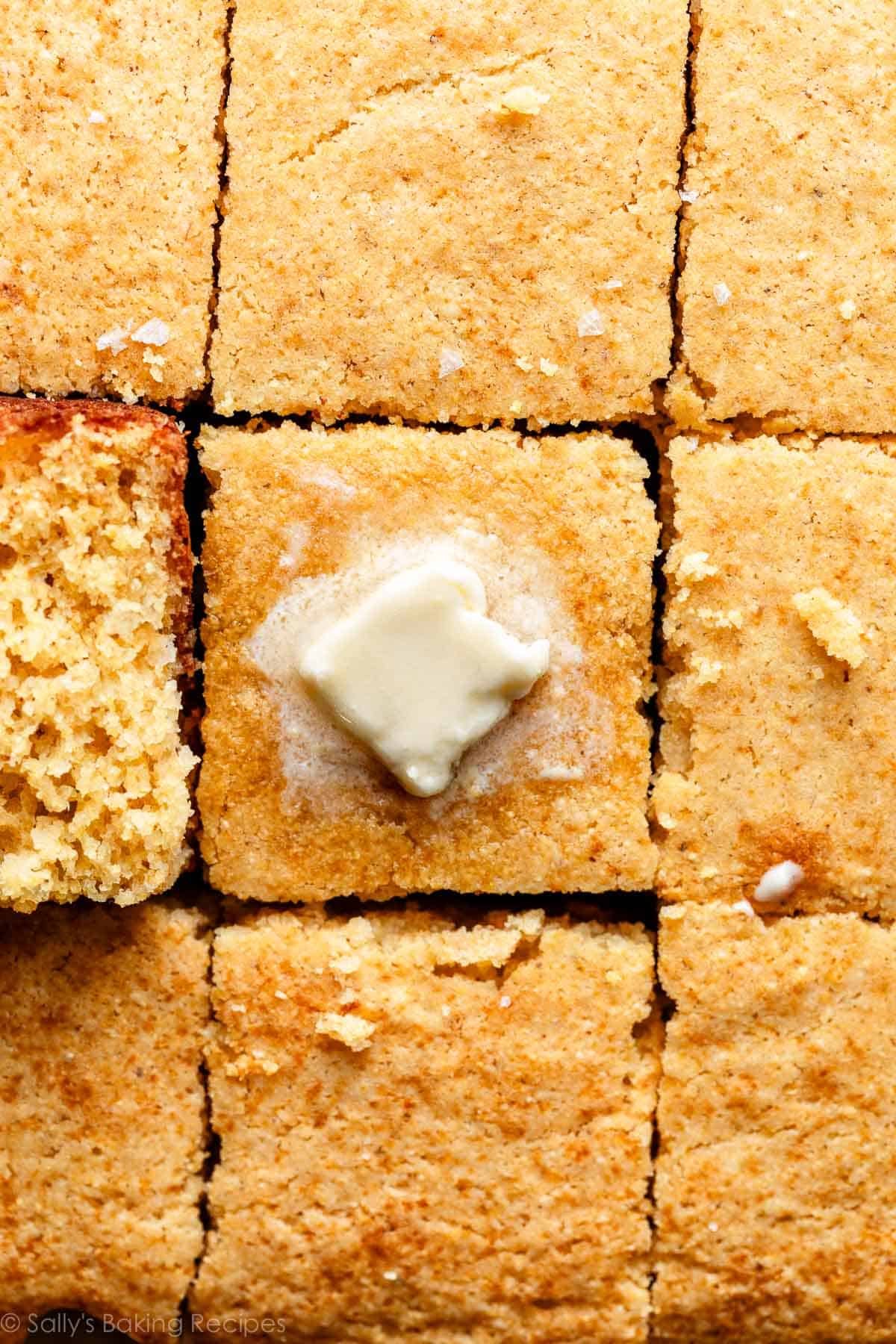 cornbread squares with butter melting on top of square in the center.