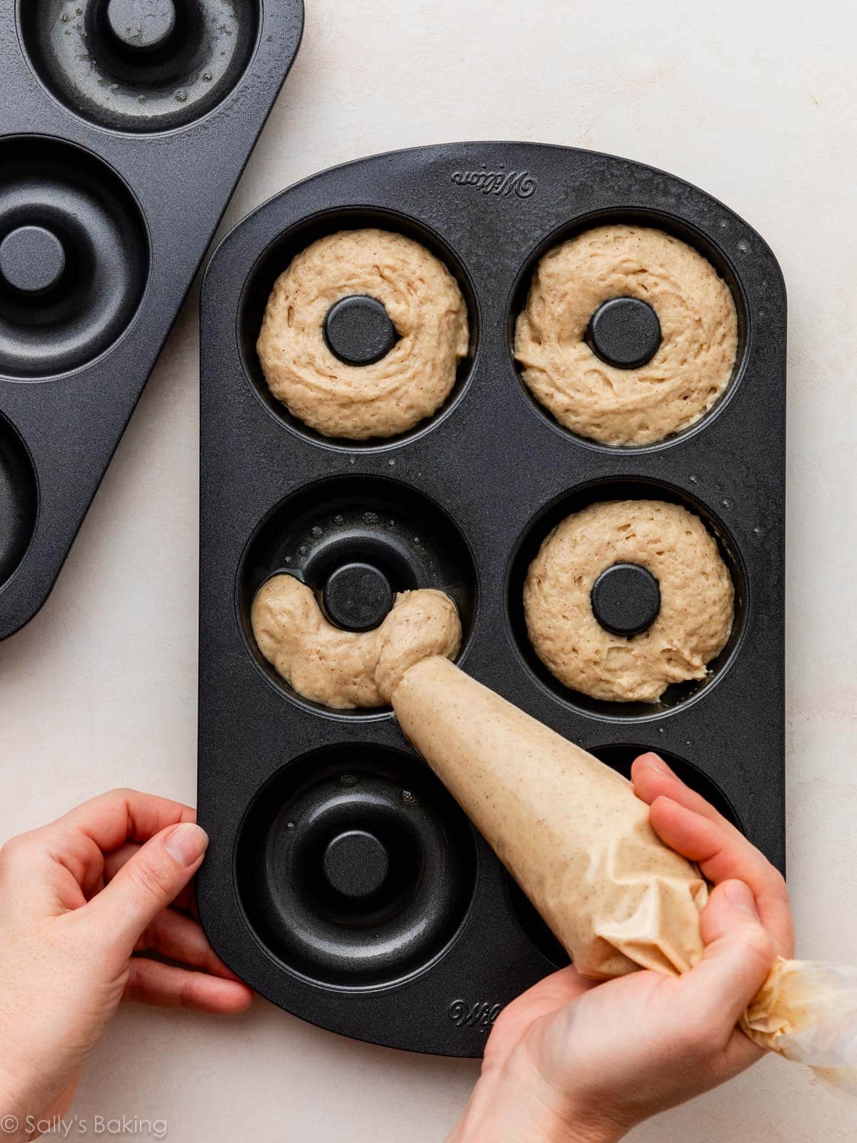 piping batter into pan.