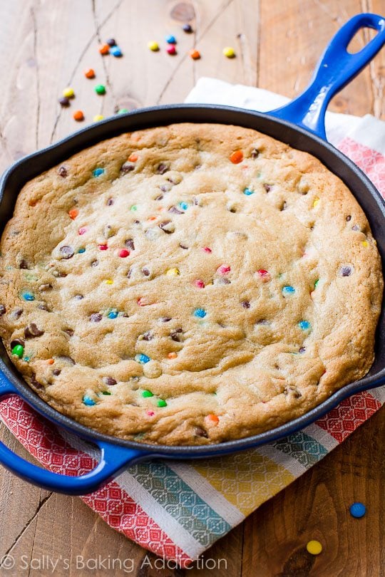 M&Ms chocolate chip skillet cookie in a blue skillet