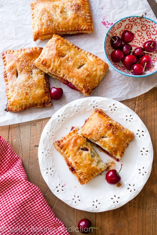 overhead image of cherry pastry pies on a white plate