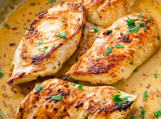 chicken with creamy cilantro lime sauce in a skillet
