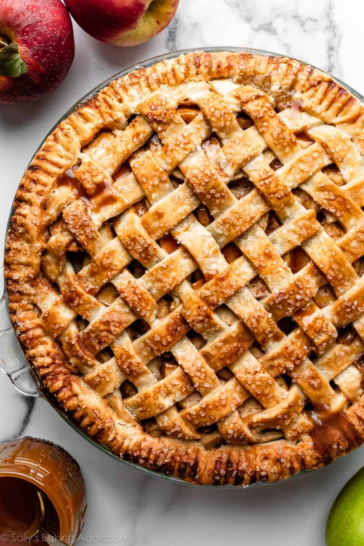 apple pie with lattice pie crust top in glass pie dish.