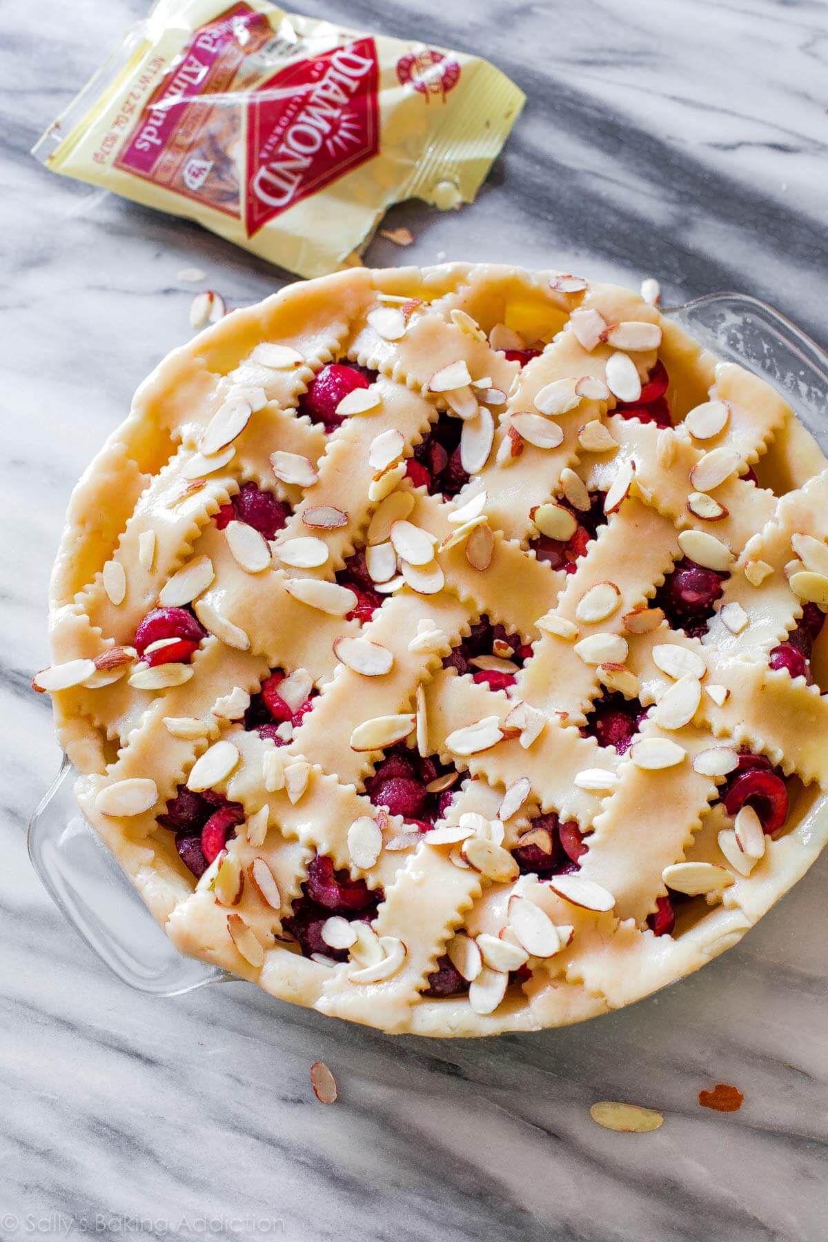 cherry pie with lattice pie dough and topped with toasted almonds before baking