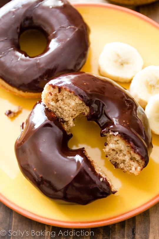 baked banana donuts with chocolate glaze on a yellow plate