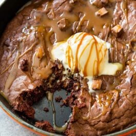 skillet brownie topped with ice cream and caramel sauce
