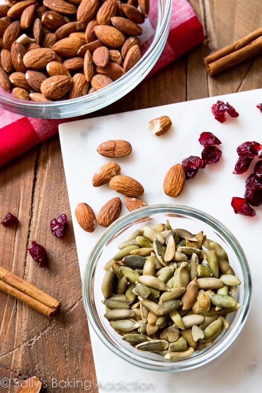 ingredients for pumpkin seed cranberry snack bars in glass bowls
