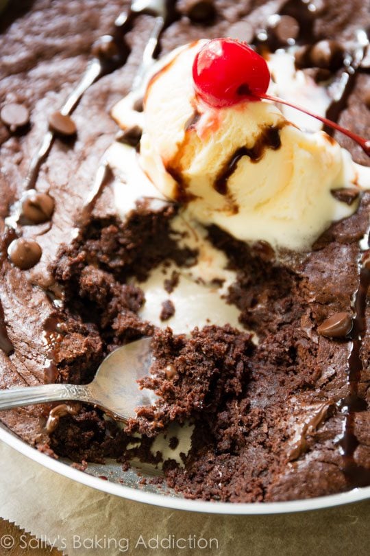 skillet brownie topped with ice cream and chocolate sauce