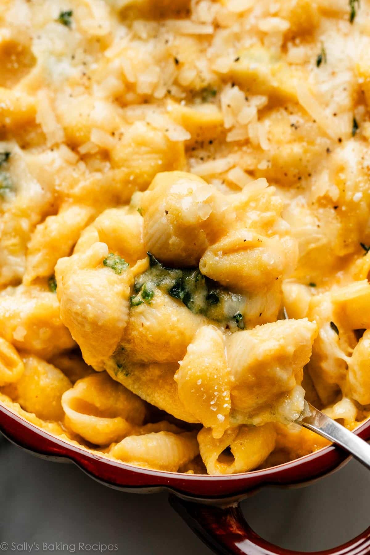 close-up photo of spoonful serving of butternut squash mac cheese with kale.
