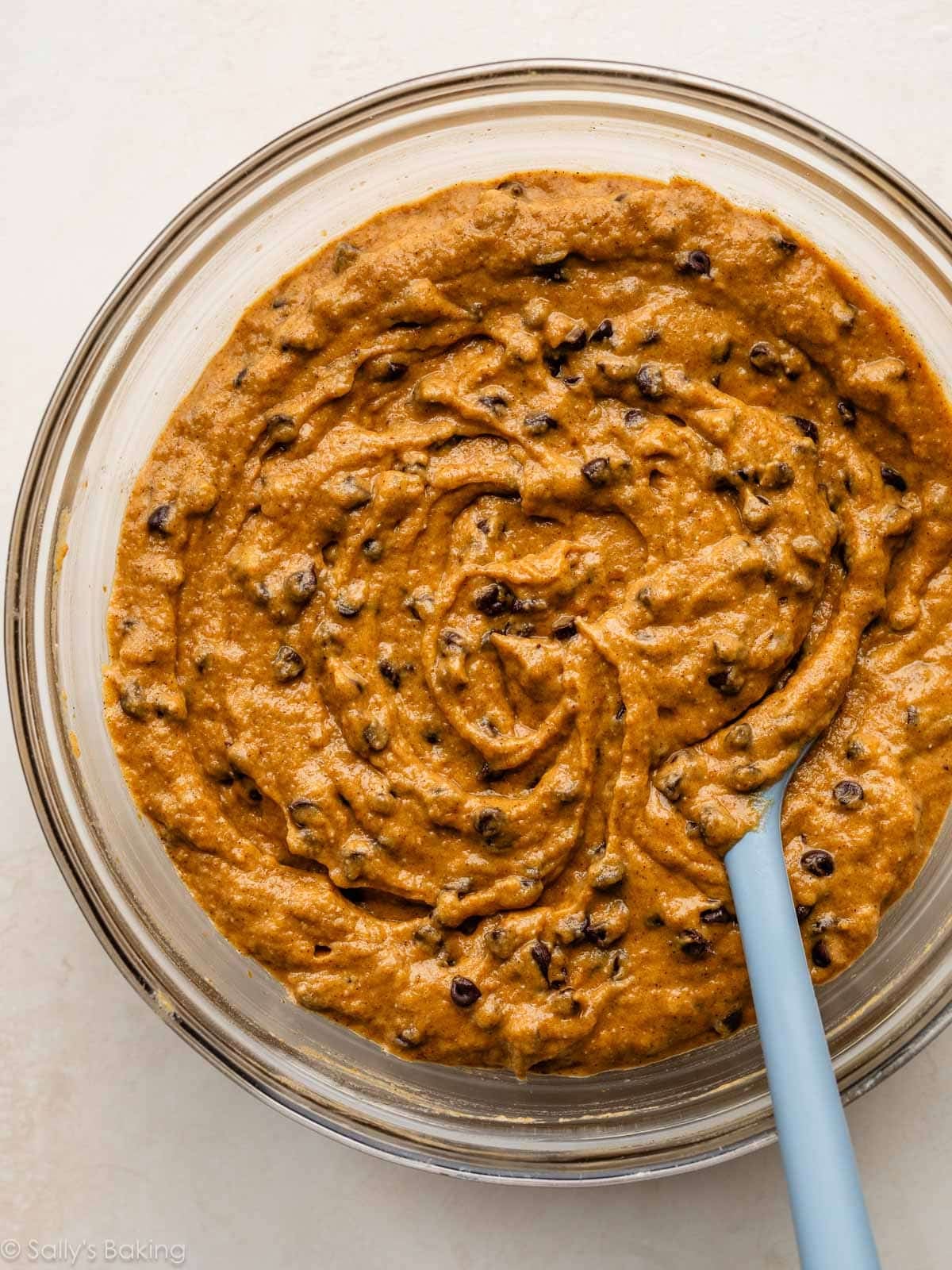 batter in glass bowl with blue spoon.