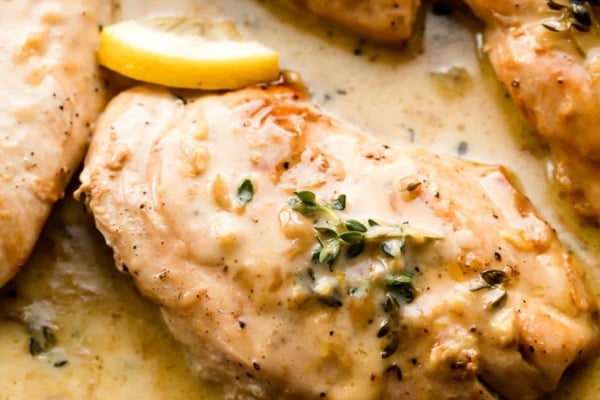 chicken breasts in creamy lemon thyme sauce in cast iron skillet