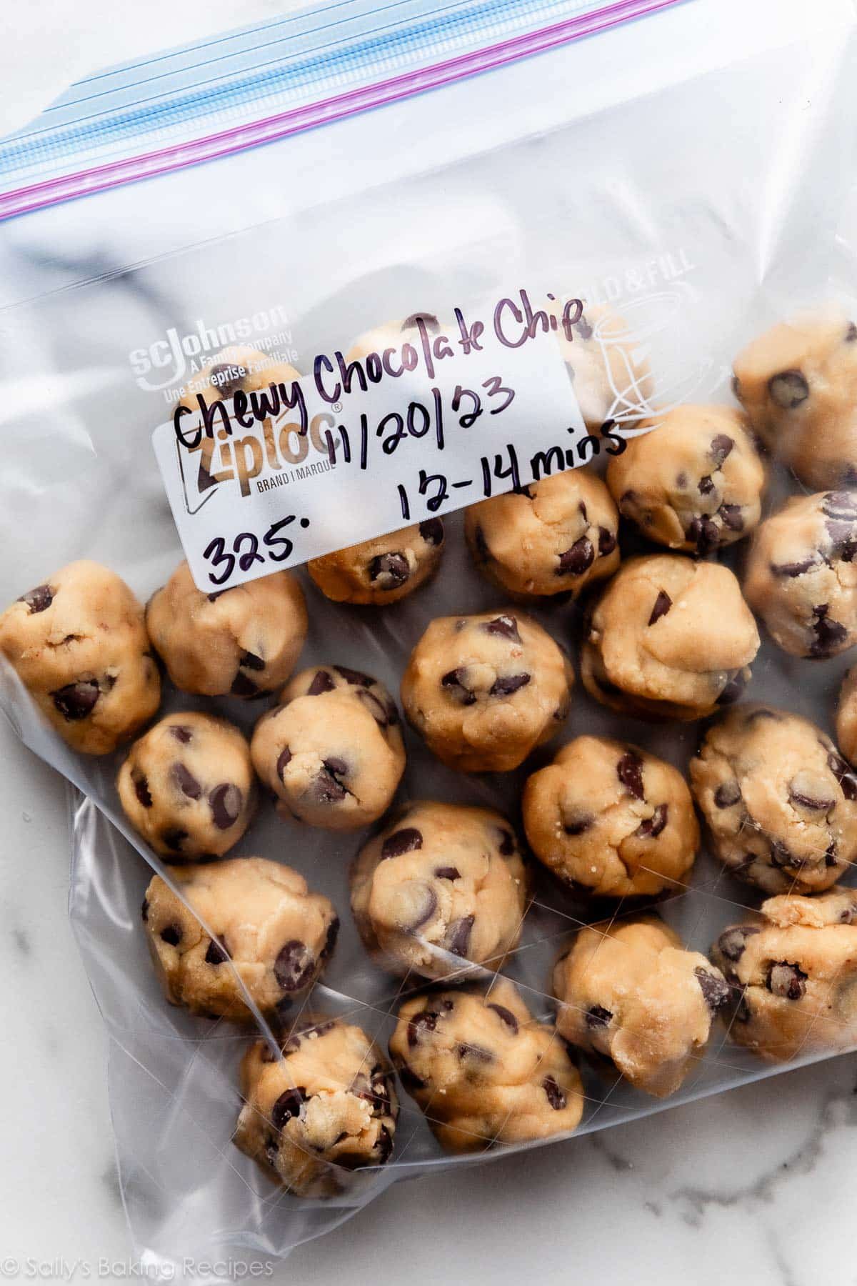 chocolate chip cookie dough balls in labeled zip-top bag with date and oven temperature.