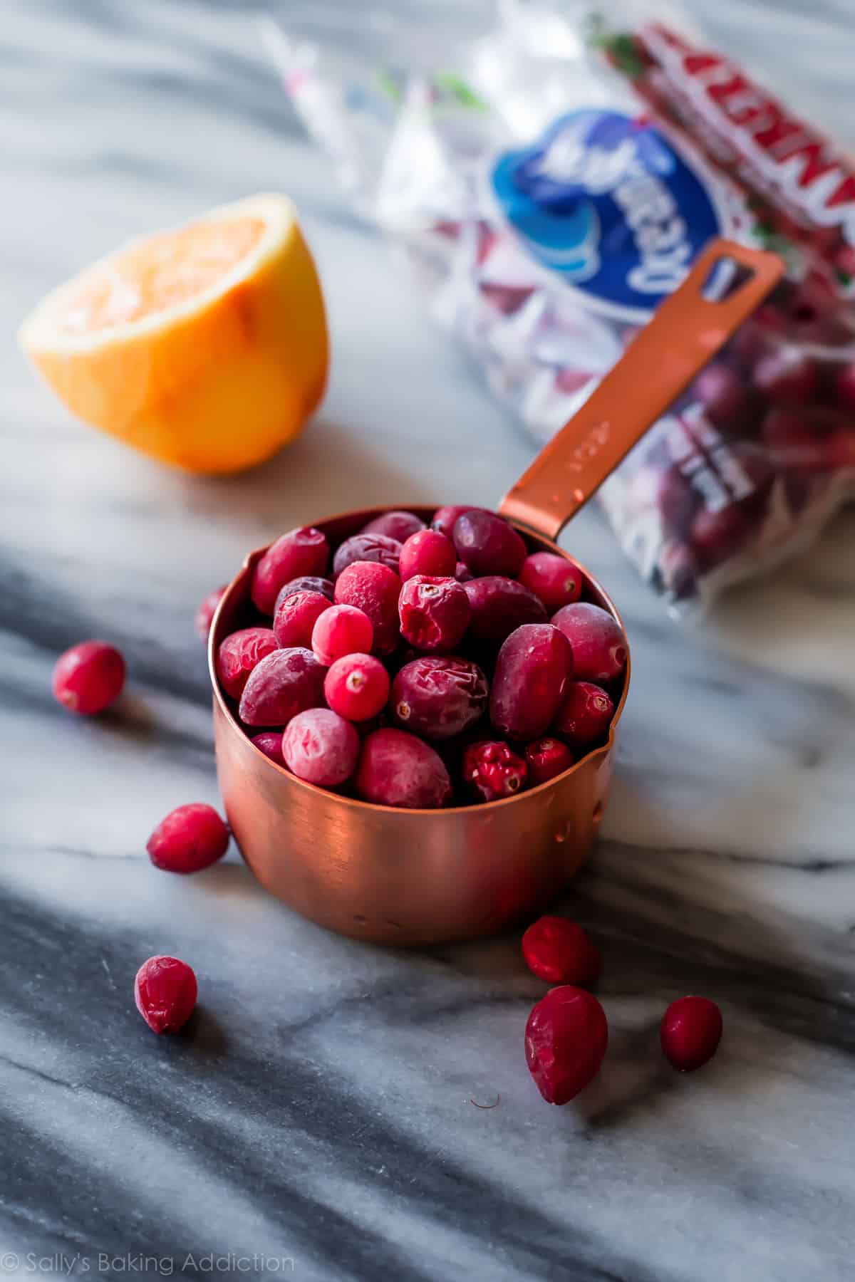 frozen cranberries in a measuring cup