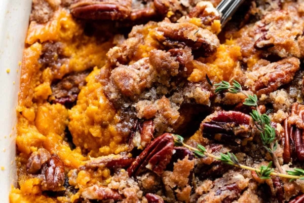 dish of sweet potato casserole with a serving spoon.
