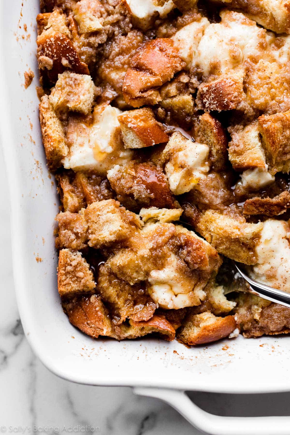 spooning a serving of baked cream cheese French toast casserole