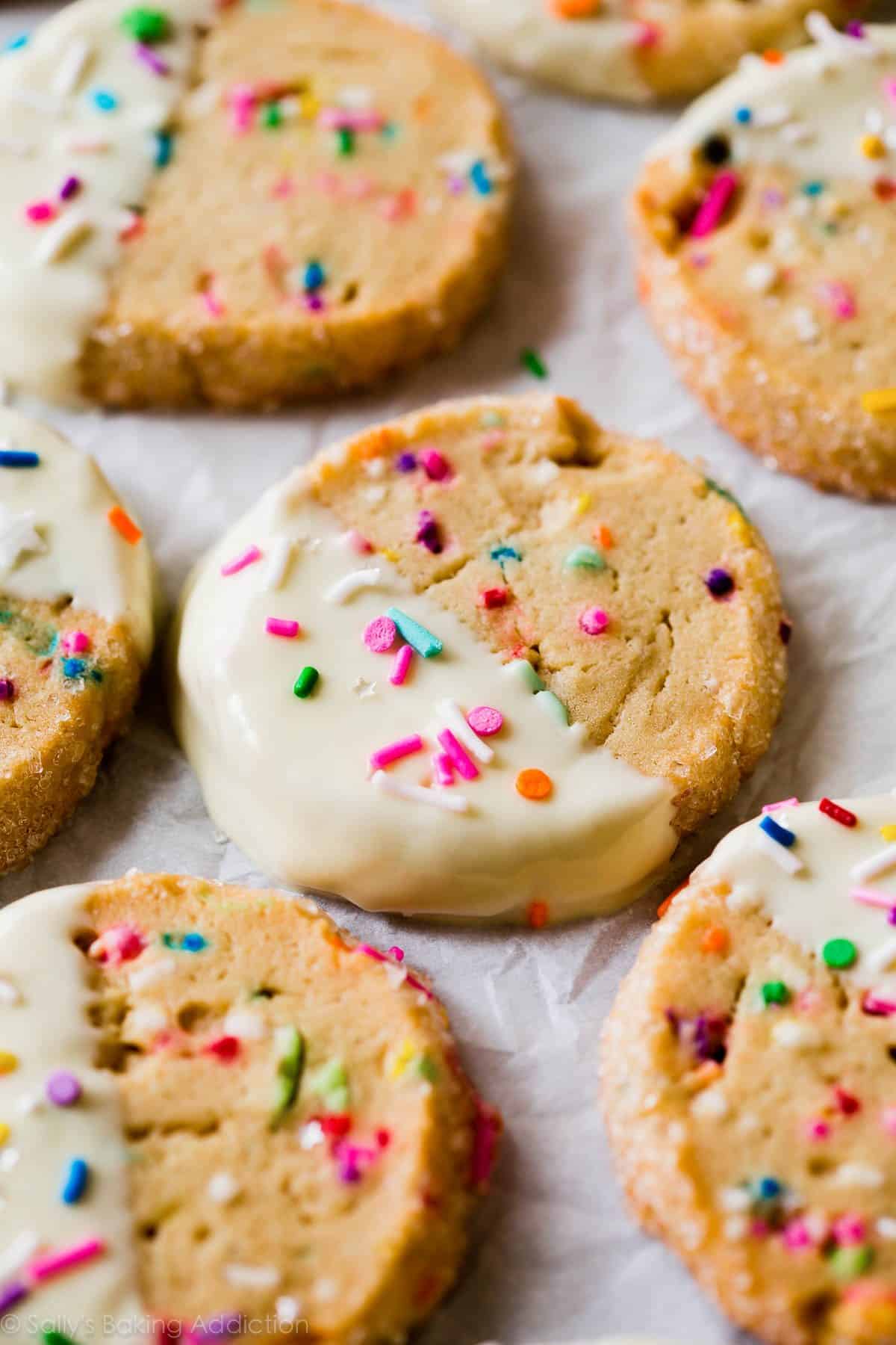 funfetti slice and bake cookies with half of each cookie dipped into white chocolate and topped with sprinkles