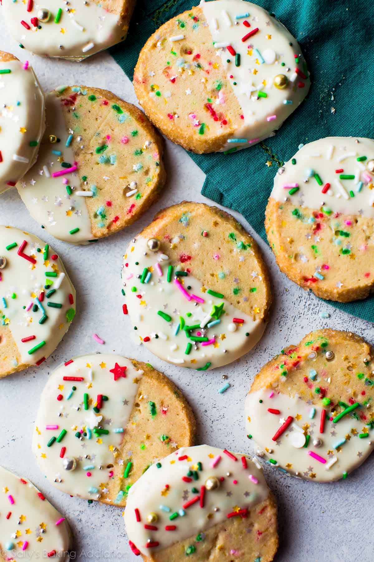 overhead image of funfetti slice and bake cookies with half of each cookie dipped into white chocolate and topped with sprinkles