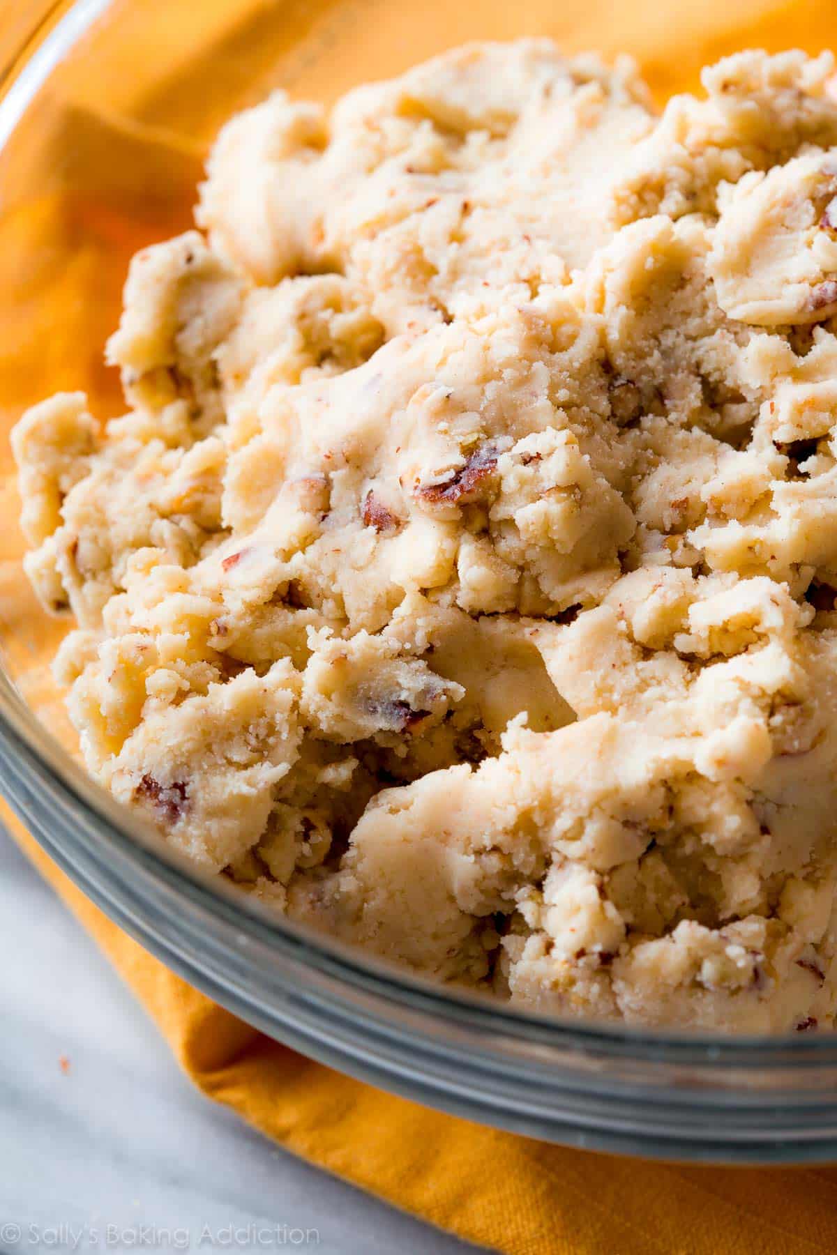 pecan snowball cookie dough in a glass bowl