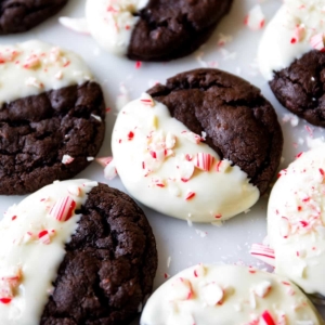 peppermint mocha cookies with half of each cookie dipped in white chocolate and topped with crushed candy canes