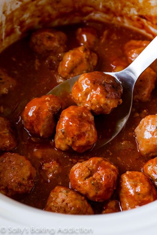 bbq turkey meatballs in a slow cooker with a serving spoon