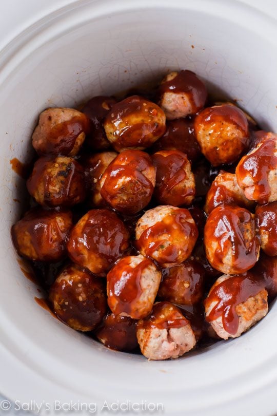 turkey meatballs in a slow cooker topped with barbecue sauce