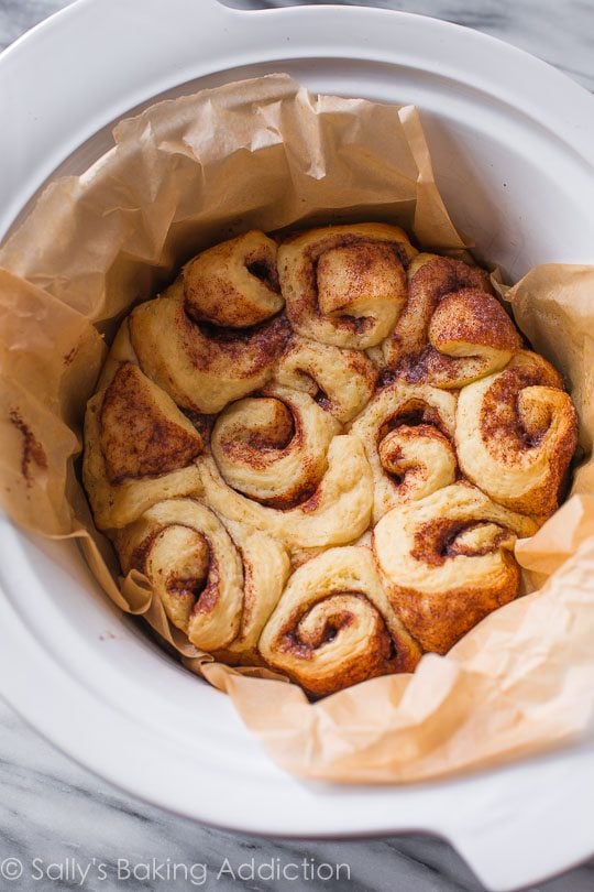 cinnamon rolls in a parchment paper lined slow cooker
