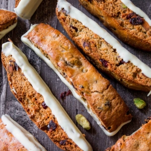 cranberry pistachio biscotti with long side dipped in chocolate