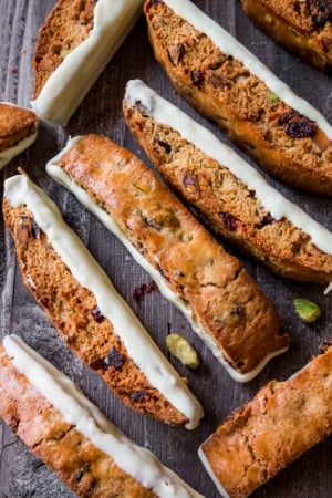cranberry pistachio biscotti with long side dipped in chocolate