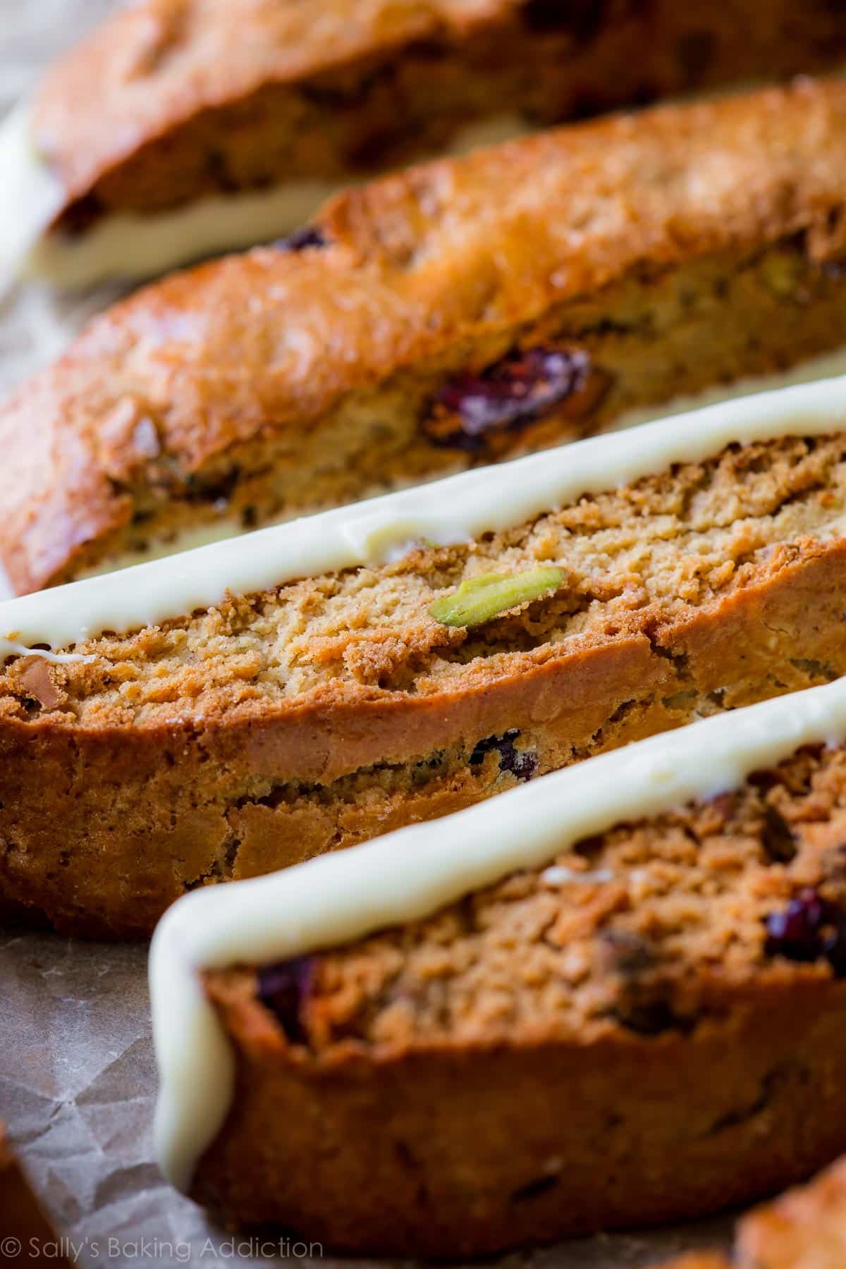cranberry pistachio biscotti with long side dipped in white chocolate