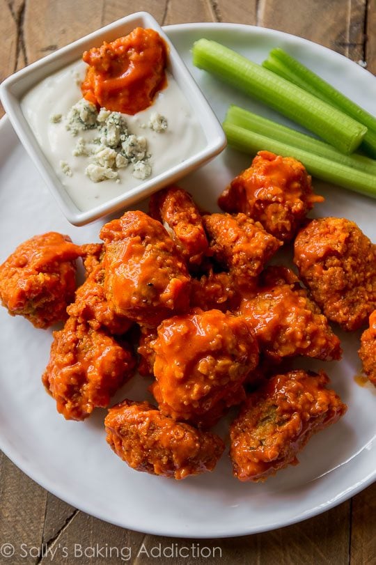 baked buffalo popcorn chicken on a white plate