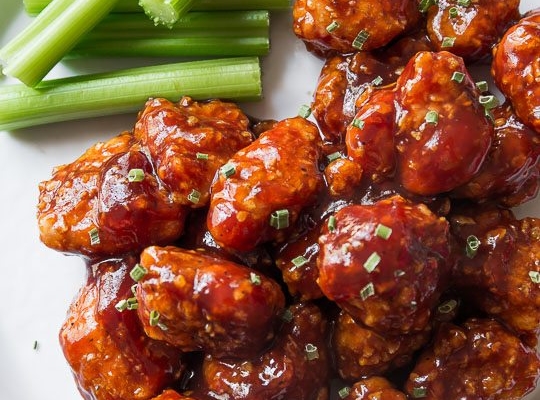 baked honey bbq popcorn chicken on a white plate