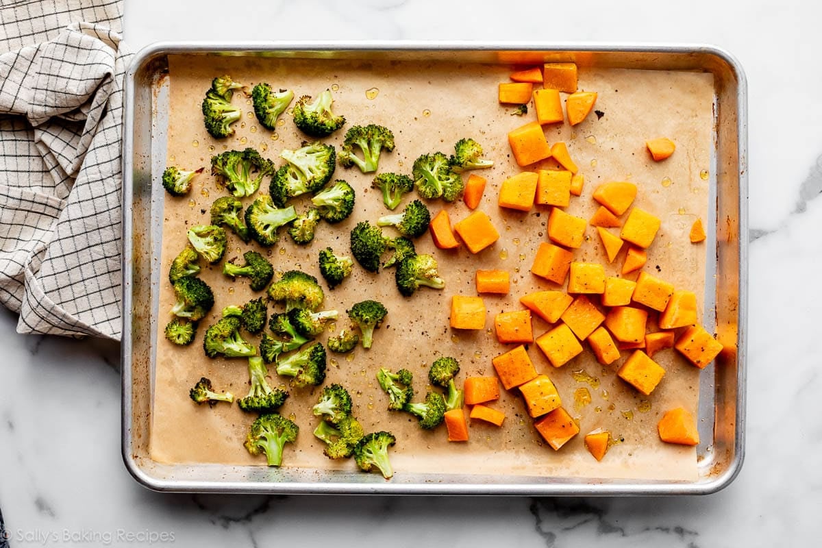 broccoli and butternut squash on parchment paper-lined baking sheet.