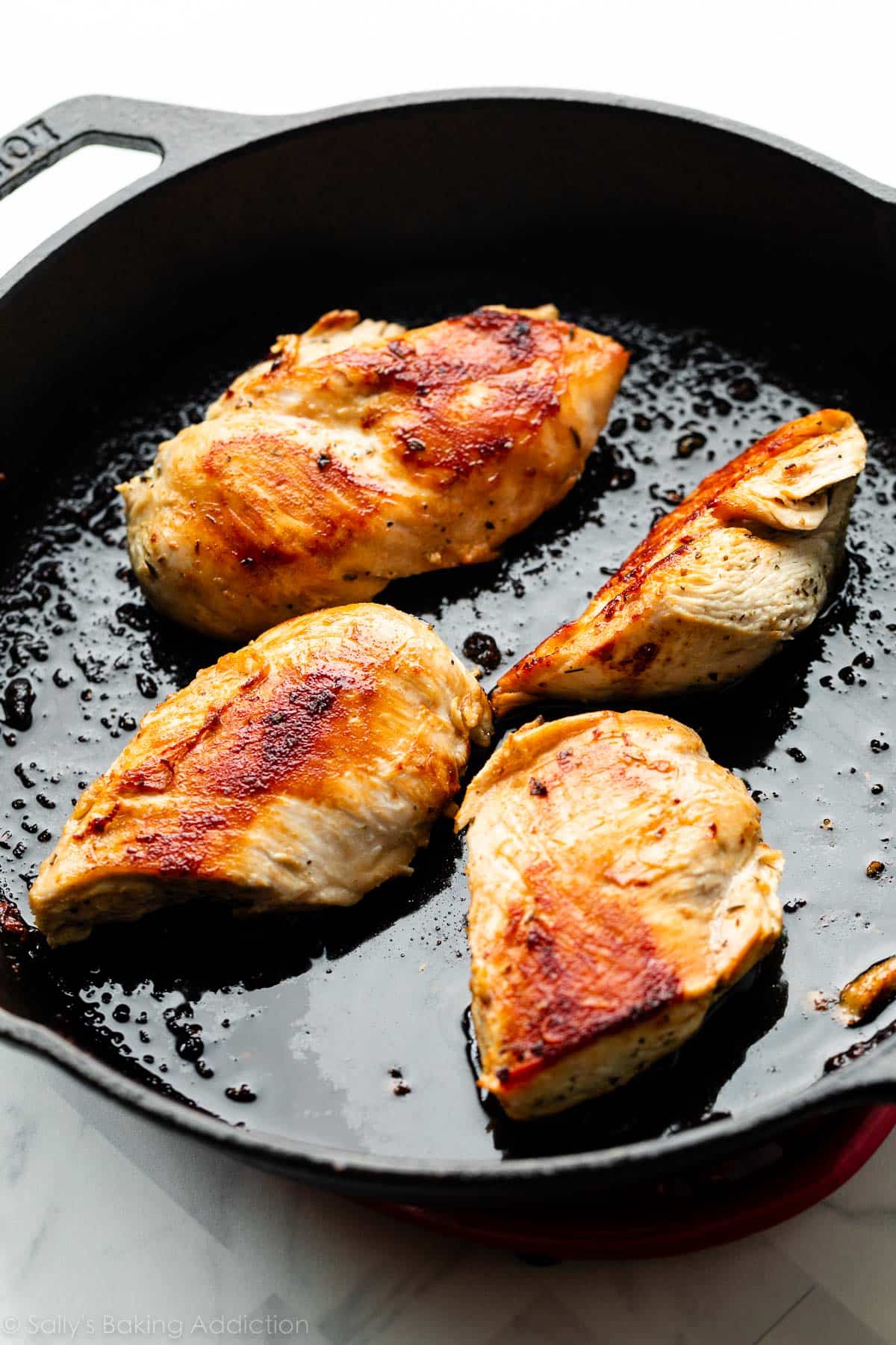 cooked chicken in cast iron skillet.