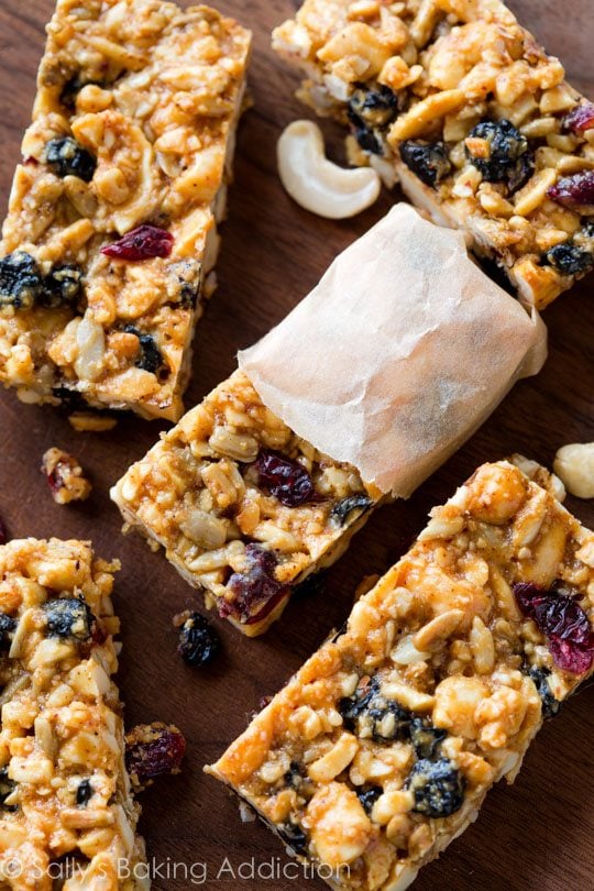 Berry vanilla cashew snack bars with one wrapped in parchment paper