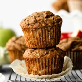 stack of two healthy apple muffins sitting on wire cooling rack.