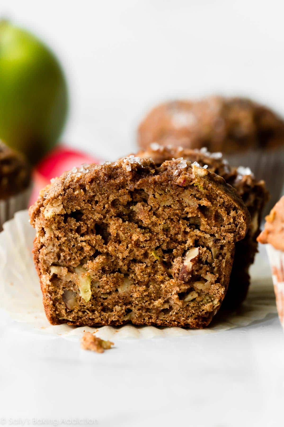 healthy apple muffin with pecans cut in half to show center.