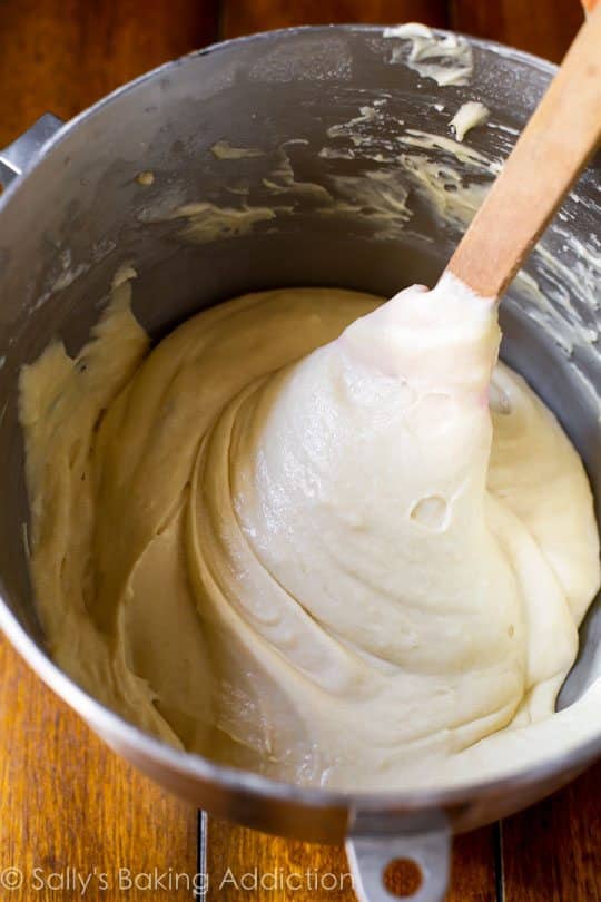 cake batter in a metal bowl with a spatula
